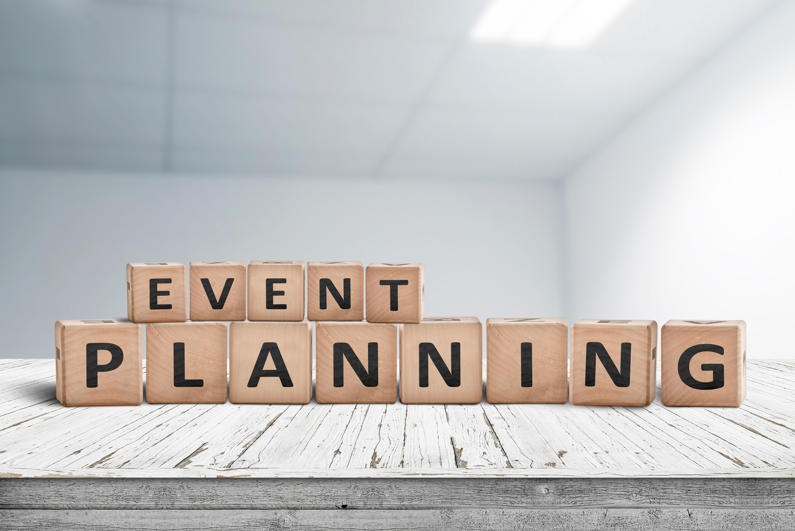 Event planning sign on a wooden desk in an office